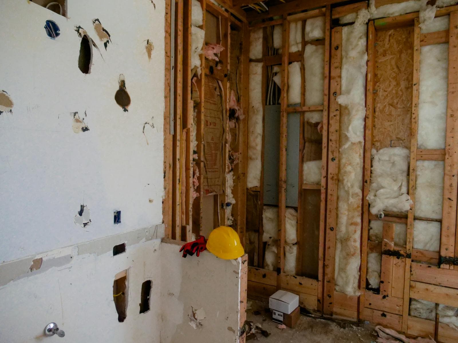 Interior wall demolition revealing damp framing and discolored sheathing during a Vancouver, WA mold remediation remodel
